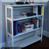 F53. White folding bookshelf. 39&rdquo;H X 37&rdquo;W X 12&rdquo;D 